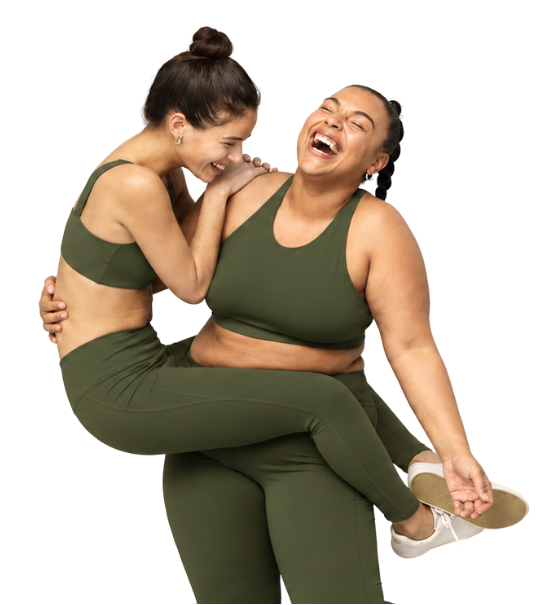 Two women in olive activewear laughing together