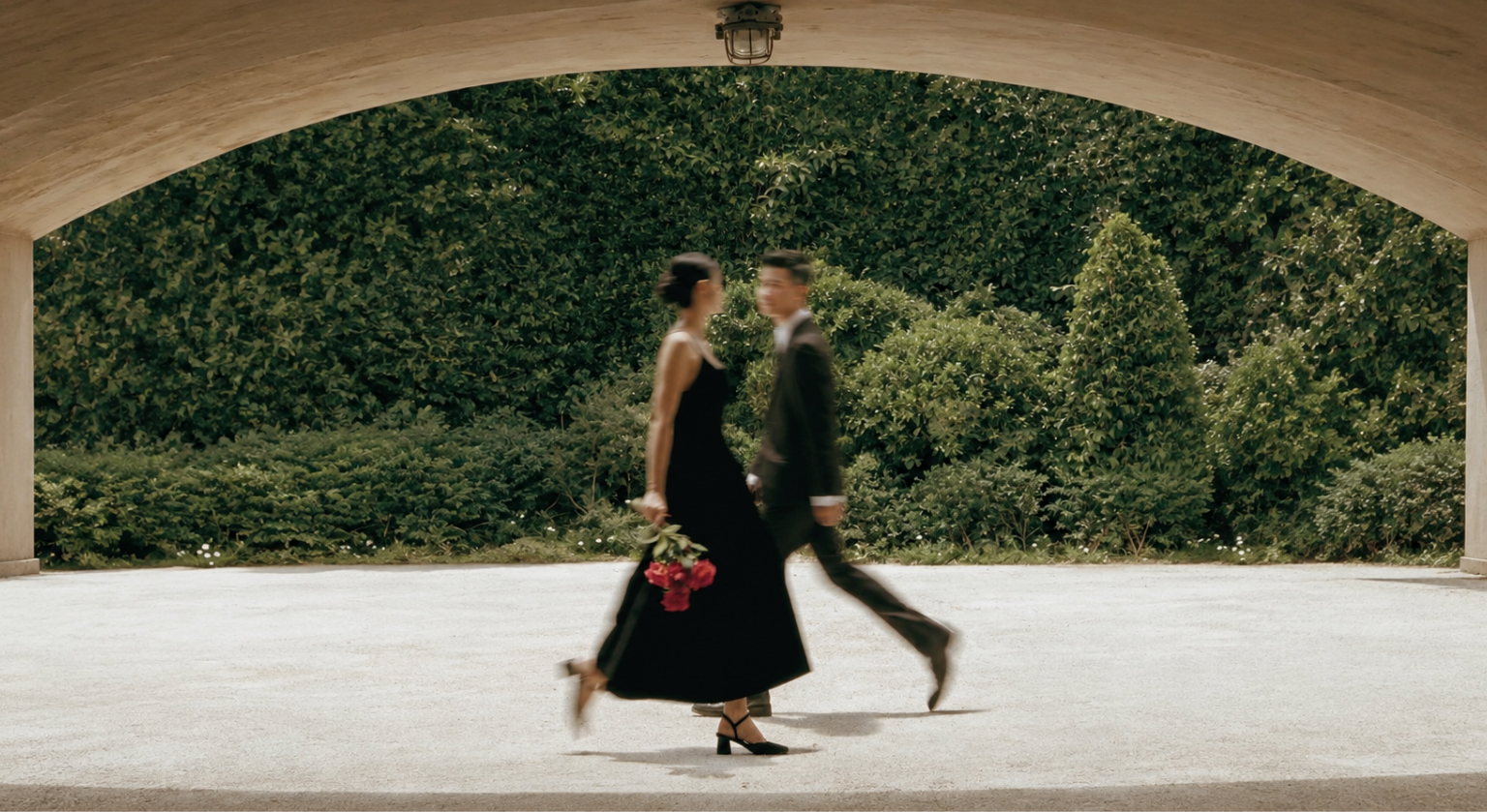 A couple walking together beneath a garden archway